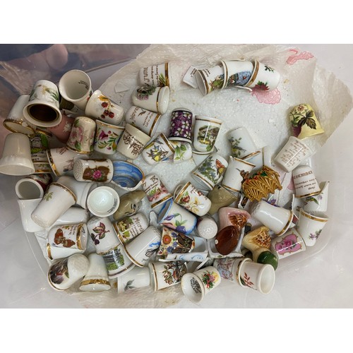 132 - A selection of porcelain thimbles, Wade tortoise trinket box, miniature plates etc..