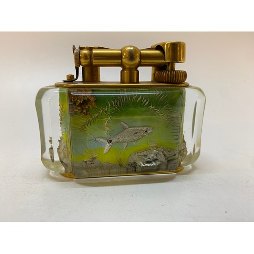 284 - A Dunhill lucite aquarium cigarette lighter with gold plated mounts - 4in. x 2in. x 3in.