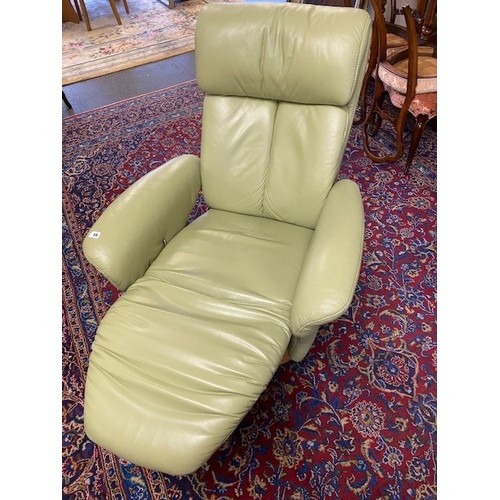 59 - A Himolla Sinatra reclining armchair upholstered in pistachio coloured green leather