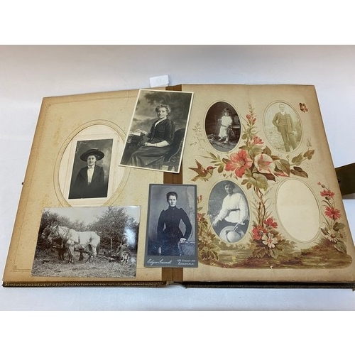 17 - A Victorian brown leather photograph album containing a selection of black and white family photogra... 