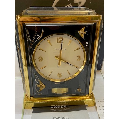 342 - A Jaeger Le Coutre Atmos clock in a lacquered brass and lucite case decorated fish, complete with ou... 