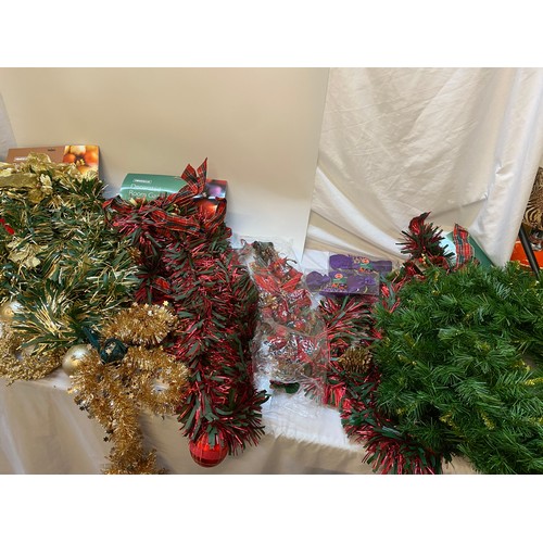 105 - A quantity of Christmas decorations including wreaths, garlands, pine tree sprigs etc..