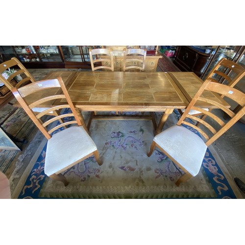 142 - A modern Baker fruitwood and flagstone inlaid drawleaf dining table on turned legs joined by an 'H' ... 