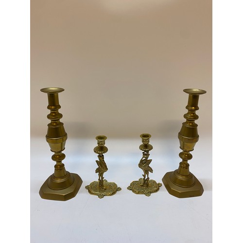 351 - A pair of large brass candlesticks with turned columns, on square bases and a pair of brass candlest... 