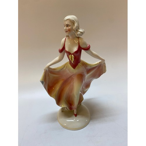 215 - A Continental model of a lady in a pink dress, on oval base - 12in. high