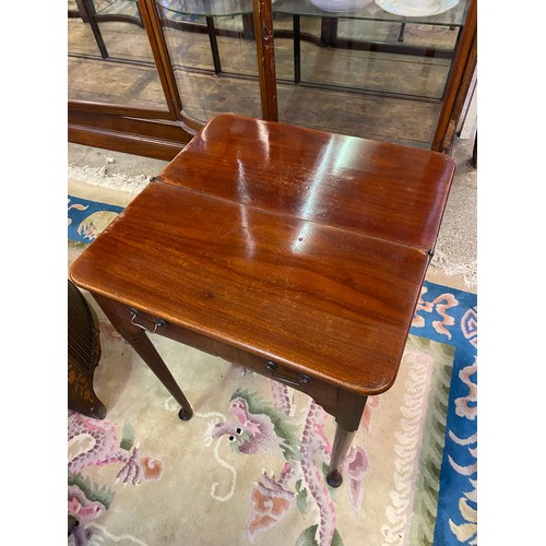 66 - A small Georgian mahogany tea table with rectangular top, frieze drawer, on cylindrical legs termina... 