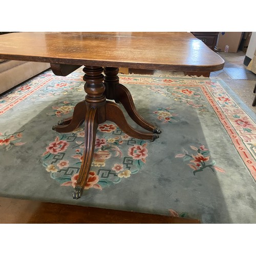 61 - A Georgian mahogany dining table with rectangular top, two extra centre leaves, on twin pillar suppo... 