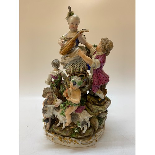 193 - A large 19th Century Meissen style group of a girl on a rock surrounded by figures and putti on goat... 