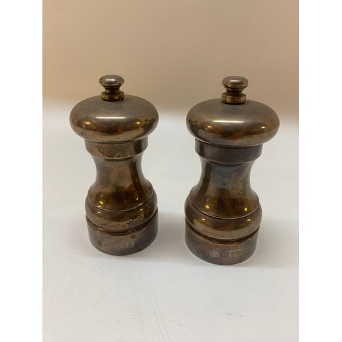 184 - A Peter Piper salt and pepper mill mounted in plain silver - London 1996 and 1997, makers marks for ... 