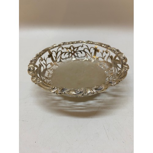 195 - A silver bon bon dish with leaf scroll border and saw pierced sides - London 1901, makers marks for ... 