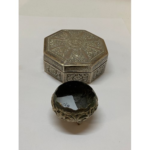 196 - An Eastern silver octagonal box with all over repousse decoration of flowers - 3 1/4in. wide and a s... 