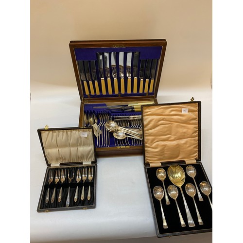 183 - An oak veneered canteen of EPNS flatware, a case of six silver plated cake forks and server and a se... 