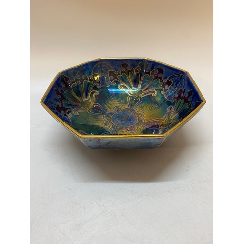 145 - An octagonal lustre bowl, blue with stylised flower and leaf decoration in green, red and gold, sign... 