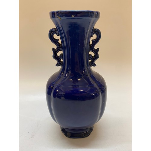 135 - A Chinese blue glazed panelled vase with stylised handles - 12in. high
