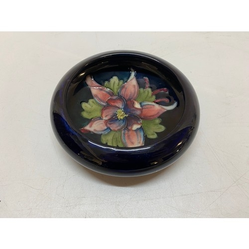 140 - A Moorcroft shallow dish, blue ground decorated columbine - 5in. dia.
