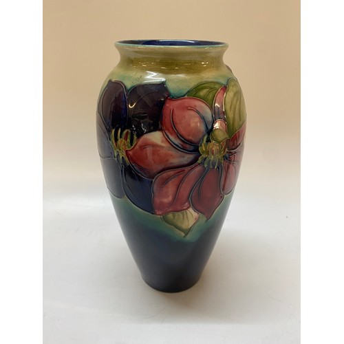 156 - A Moorcroft baluster form vase, shaded green to blue decorated clematis, blue mark to the base and i... 