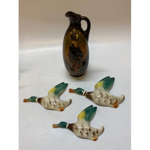 146 - A Royal Doulton whisky jug decorated Scotsman and three flying ducks