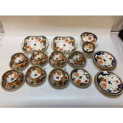 144 - A Shelley part tea service painted flowers in the Oriental taste within blue and gilt borders compri... 