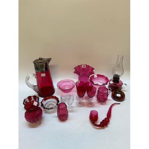171 - Cranberry glass comprising:- iced water jug with silver plated mounts, oil lamp, vases, wines, pipe ... 