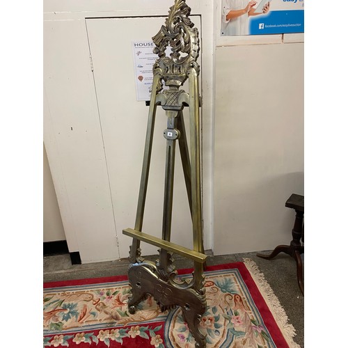 97 - A modern silver sprayed floor standing picture easel with scroll back