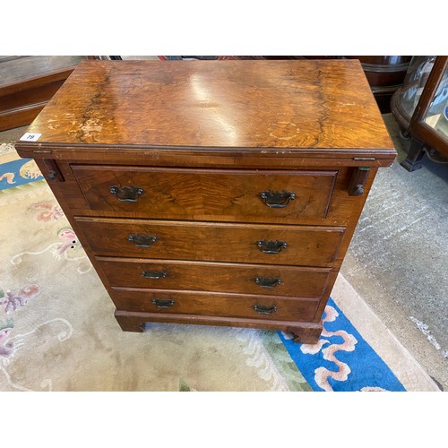 79 - A reproduction walnut veneered bachelors chest with folding top, fitted four wide drawers, on bracke... 