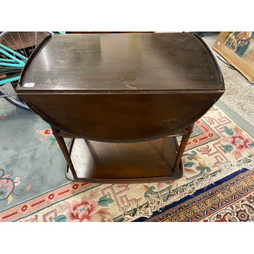 77 - A mahogany three tier tea trolley fitted two rounded drop flaps