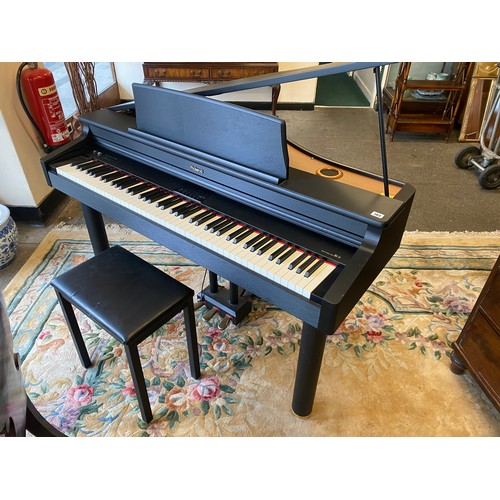 103 - A modern Roland electric piano in a black case complete with stool and metal music stand