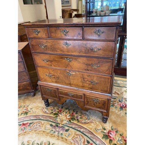87 - A Queen Anne walnut veneered chest on stand, the upper part fitted three narrow and three wide drawe... 