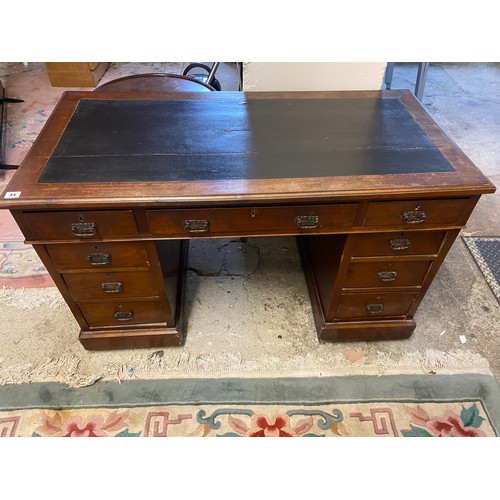 94 - An Edwardian mahogany desk, the top inset black rexine writing surface, fitted three frieze drawers ... 