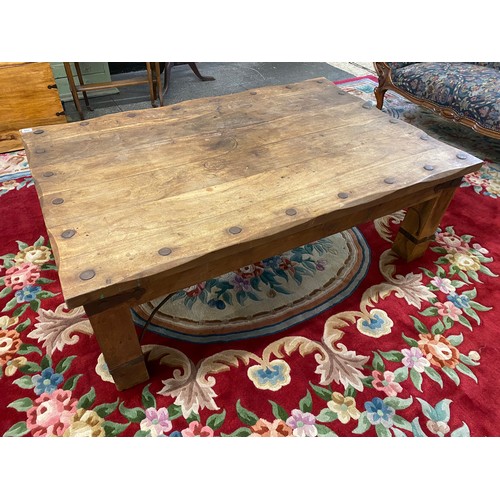 119 - A modern Eastern hardwood coffee table with rectangular top, on square legs, with metal stud and str... 