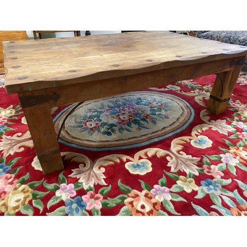 119 - A modern Eastern hardwood coffee table with rectangular top, on square legs, with metal stud and str... 
