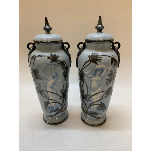 152 - A pair of Rosenthal Copenhagen pate sur pate style vases and covers decorated with semi nude females... 