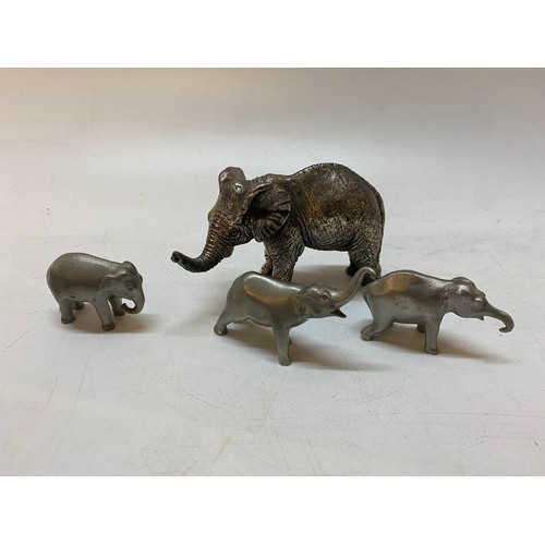 193 - A Country Artists silver covered resin model of an elephant - 2 1/2in. high and three Selangor pewte... 