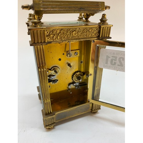 251 - A carriage clock, white enamel dial, secondary dial, striking movement on a gong, in a brass and gla... 