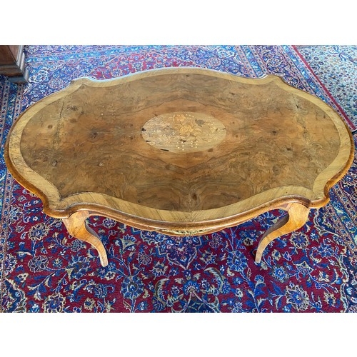 46 - A French walnut and crossbanded centre table with floral marquetry inlaid centre, serpentine border,... 