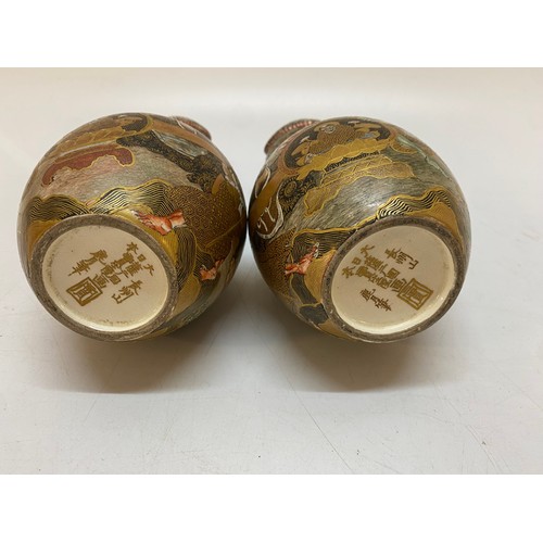 149 - A pair of Japanese Satsuma double gourd shaped vases, gold ground decorated Immortals and coiling dr... 