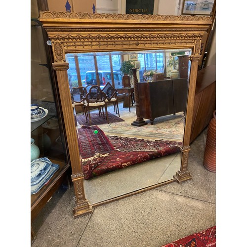 51 - A rectangular bevelled wall mirror in a 19th Century gilt metal frame with anthemium leaf, swag and ... 