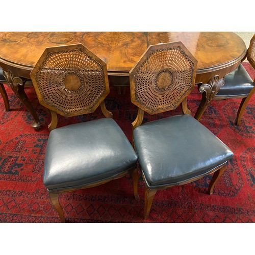 43 - A walnut dining room suite comprising:- extending table with rounded ends, raised on cabriole legs -... 