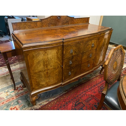 43 - A walnut dining room suite comprising:- extending table with rounded ends, raised on cabriole legs -... 