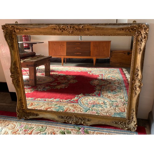 92 - A large rectangular wall mirror in a decorative gilt frame - 40in. x 49in.