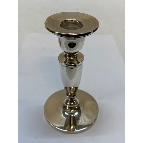 173 - A silver table bell, a cut glass sugar castor with silver top and a plain silver candlestick with ta... 