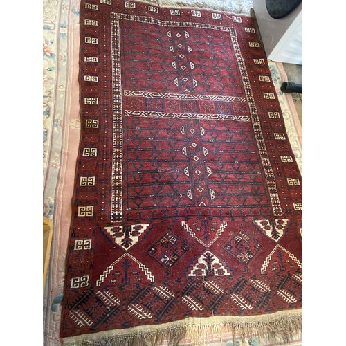 2 - A Persian rug, red field with rectangular medallion to the centre in white with stylised decoration,... 