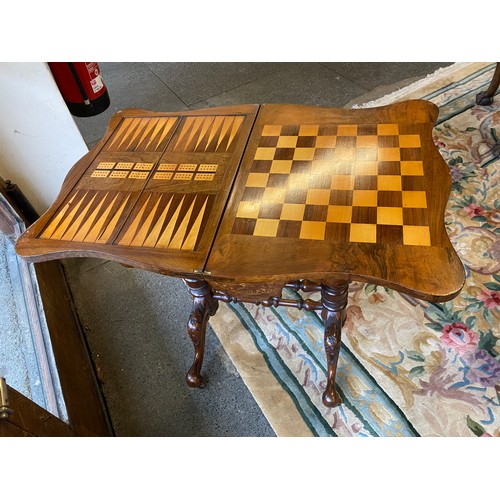 40 - A Victorian burr walnut and inlaid games/work table with revolving top, sewing basket under, on turn... 