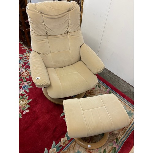 81 - A Stressless armchair and matching stool upholstered in cream material