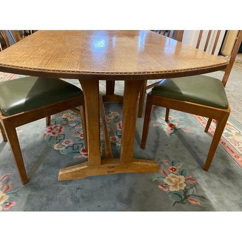 49 - An oak dining room suite comprising:- dining table with shaped rectangular top, on trestle ends - 56... 