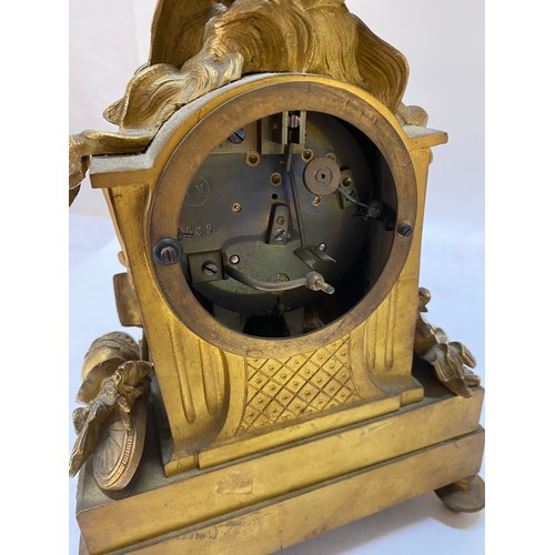 293 - A 19th Century mantel clock with circular white enamel dial, striking movement, in a gilded ormolu c... 