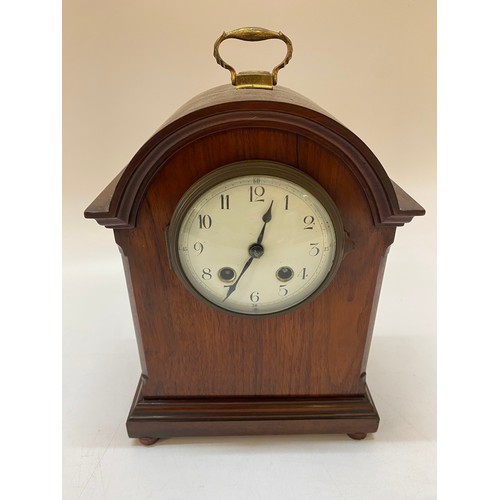 301 - An Edwardian mantel clock with white enamel dial, a mahogany case with domed top and brass carrying ... 