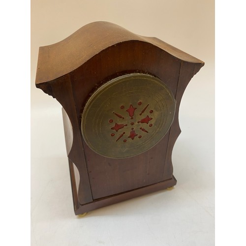 302 - An Edwardian mantel clock with white enamel dial, in a mahogany case with inlaid paterae to the fron... 