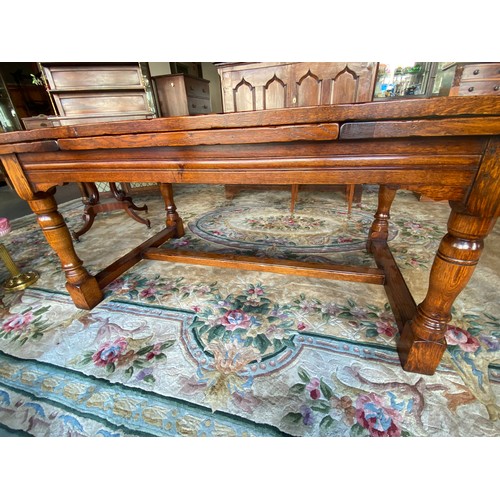 51 - A reproduction oak refectory style dining table on turned supports - 72in. x 38in.