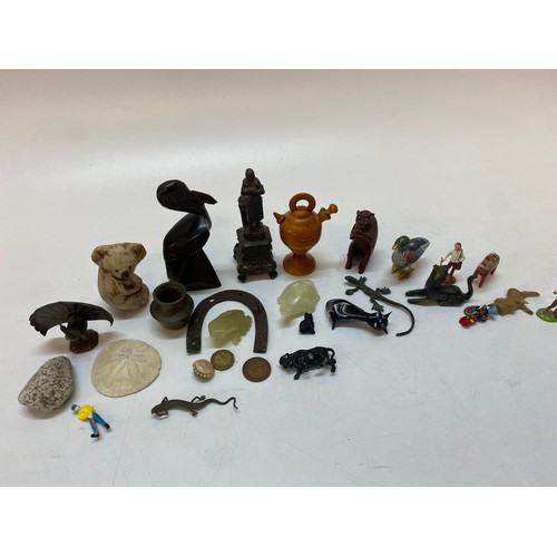 210 - A small Cloisonne model of a duck, a carved wood model of a pelican, a carved wood model of a monkey... 